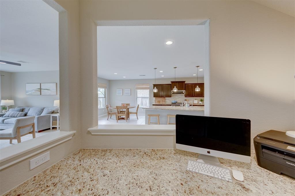 The study nook sports a wrap-around granite work area and built-in storage.