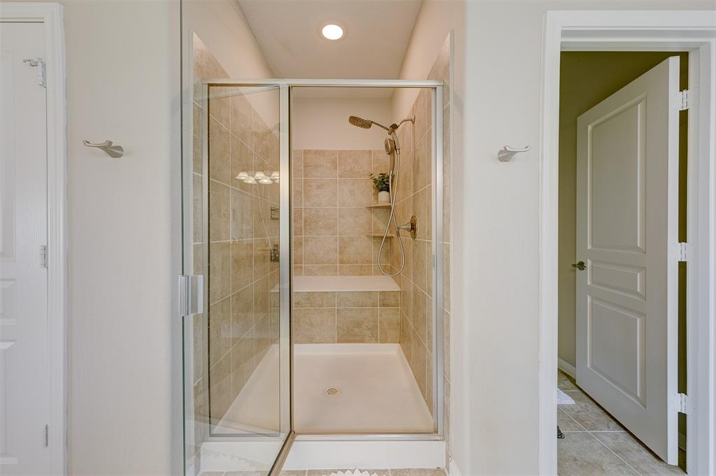 The shower is very deep and has a super large bench in the rear.