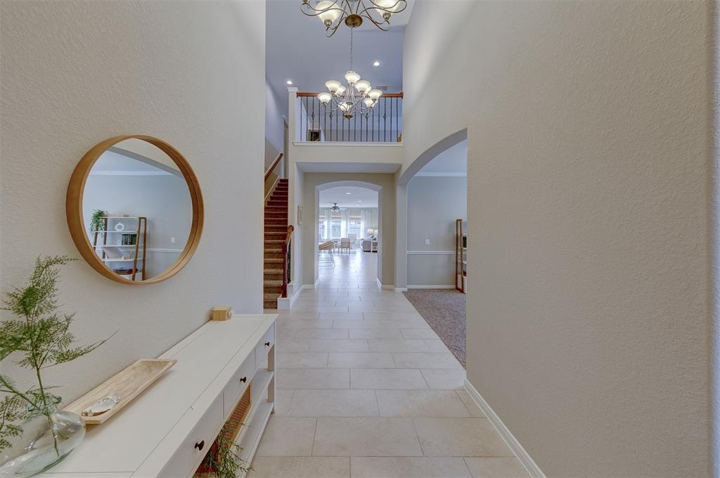 From the front door you see the attractive tiled entry. The guest bedroom and full bath are to the right. Next on the right is the sitting room. The hallway on the left by the stairway leads to the mud room, the utility room, and the study.