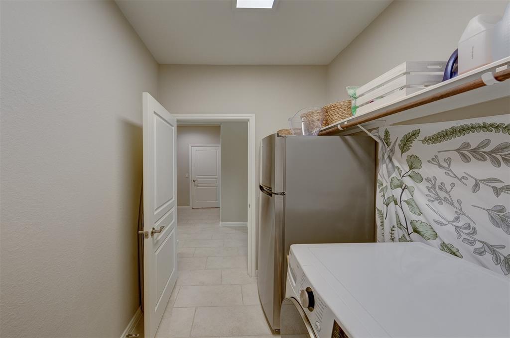 The laundry room is tucked away near the flex room with easy access to the back door and garage.