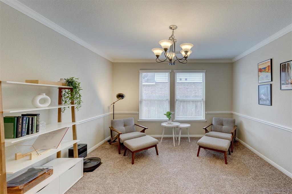 The sitting room also could be used as a formal dining room.The chair rail, crown molding and rounded drywall outside corners are just some of the attractive features.