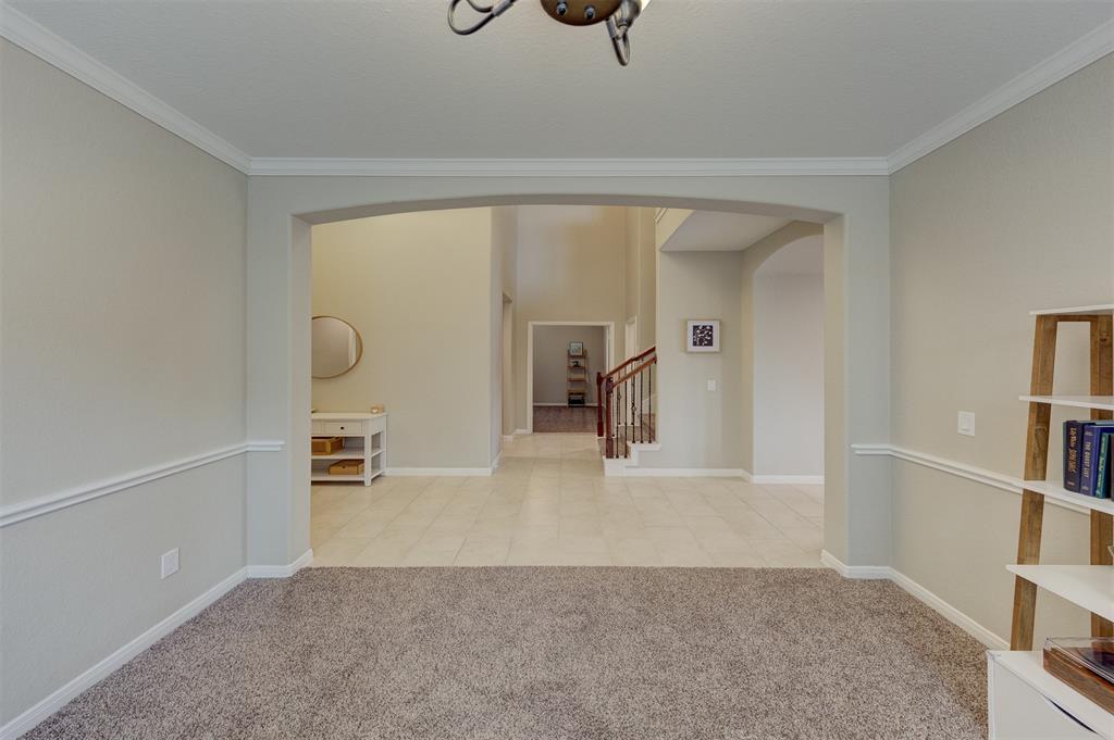 The study is visible across the hallway past the stairs.