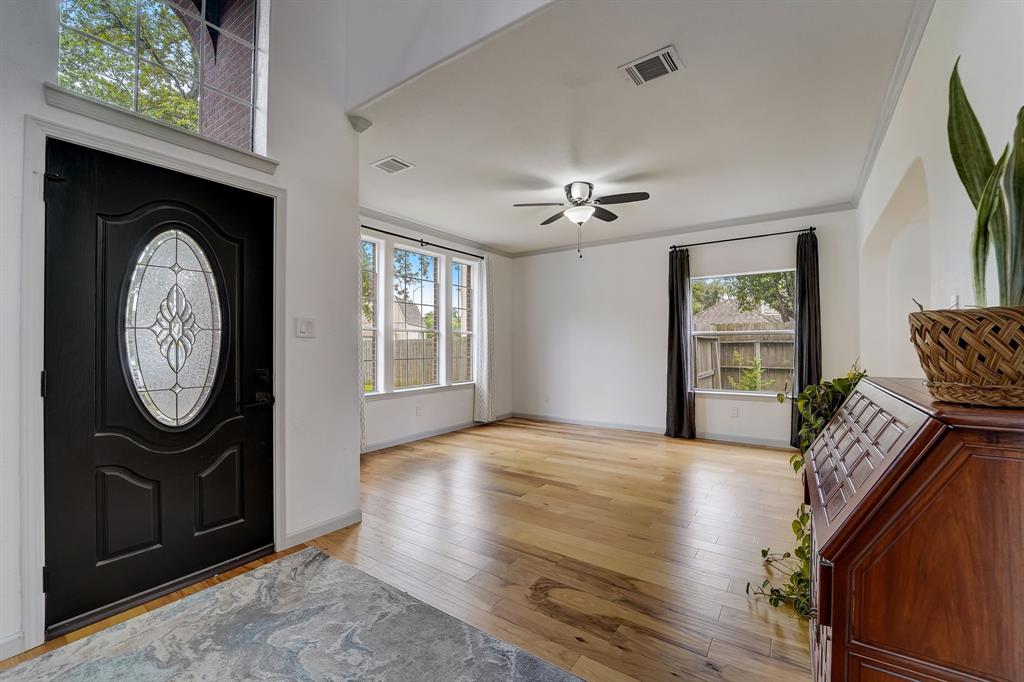 Hardwood floor flows through the first floor, complimenting the high ceilings and natural light