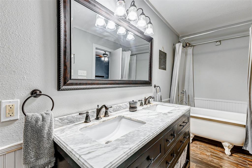 Indulge in elegance and relaxation! This stunning primary bathroom features a charming clawfoot freestanding tub, offering a luxurious escape from the everyday hustle and bustle. Experience serenity and style at its finest.