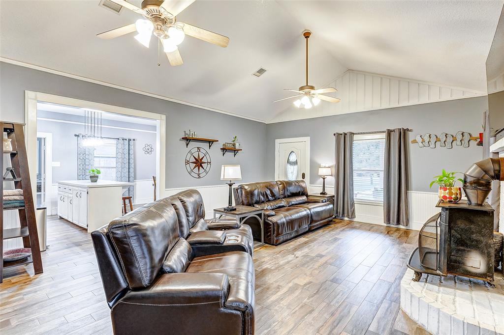 Cozy up by the crackling fireplace in this inviting living room, where ample space for two large couches invites warmth and togetherness.