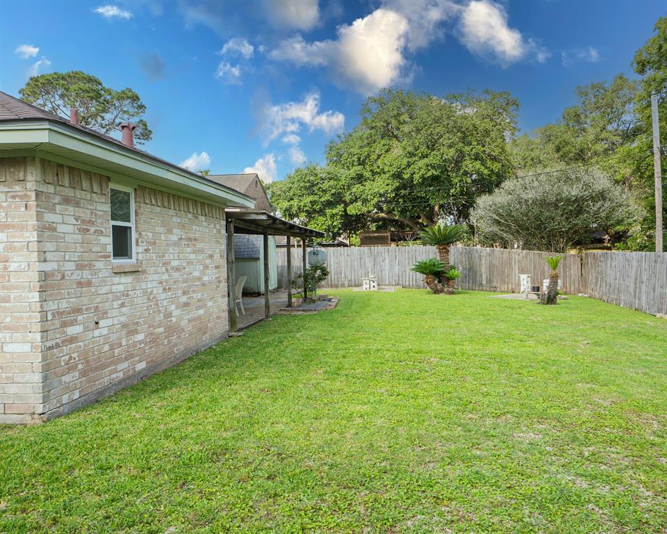 Plenty of room in the fully fenced back yard for kids of all ages