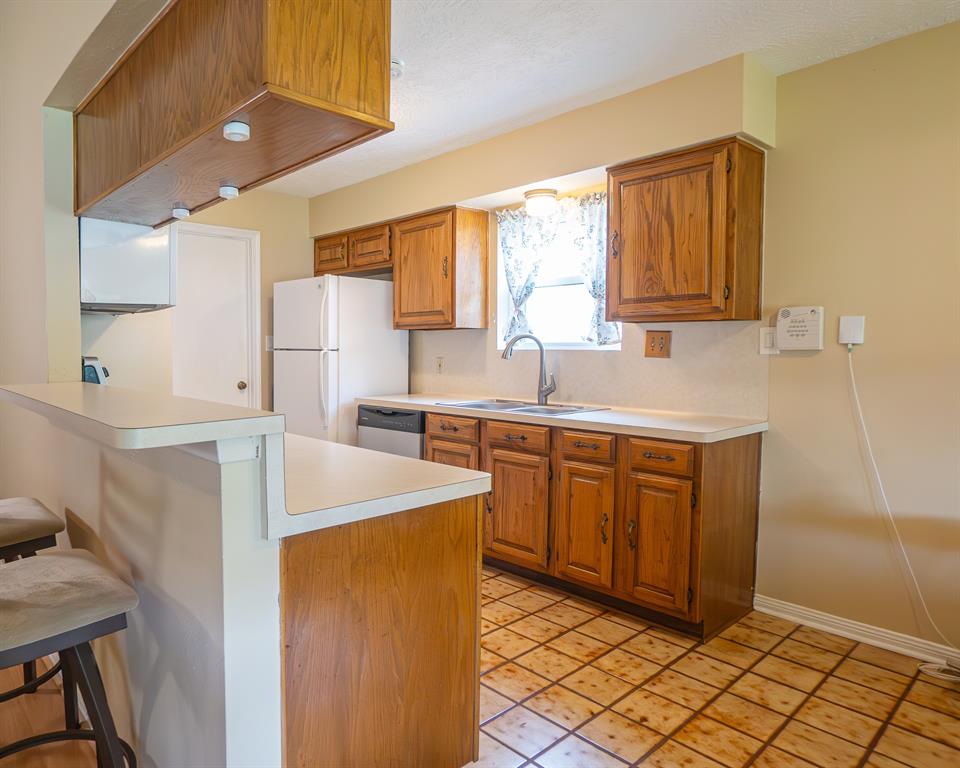 Kitchen opens to the living room and dining area. Laundry room located next to kitchen