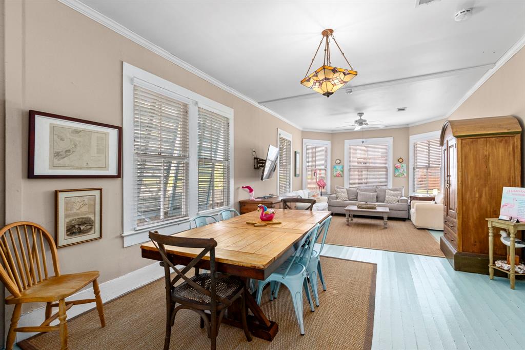 Plenty of room to gather around this table for family time and share memories at the beach! Historic Galveston art on walls transfers to new owner!