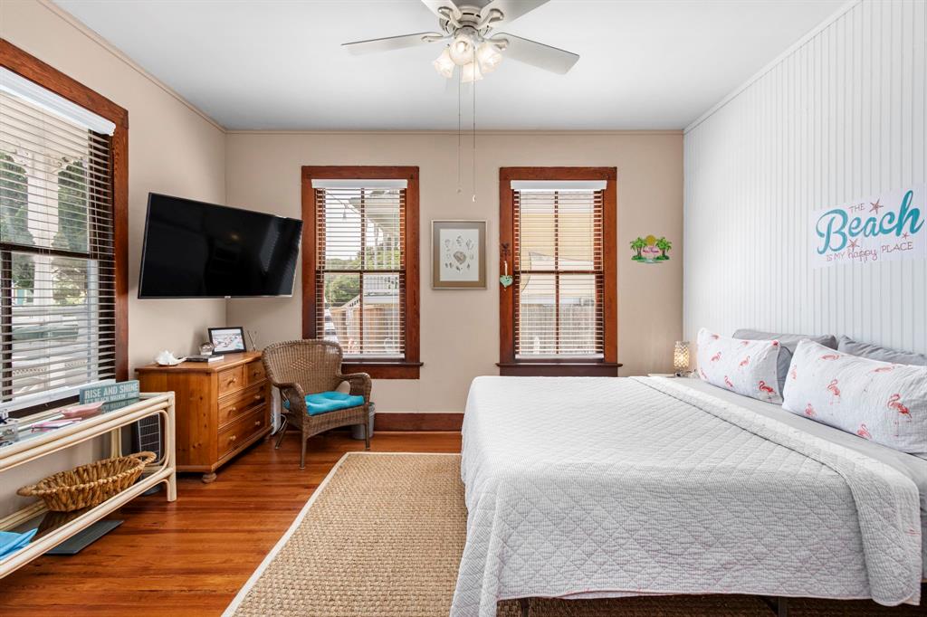 Spacious primary bedroom with king bed and antique trim around antique wood windows! Notice the ship lap on the wall!