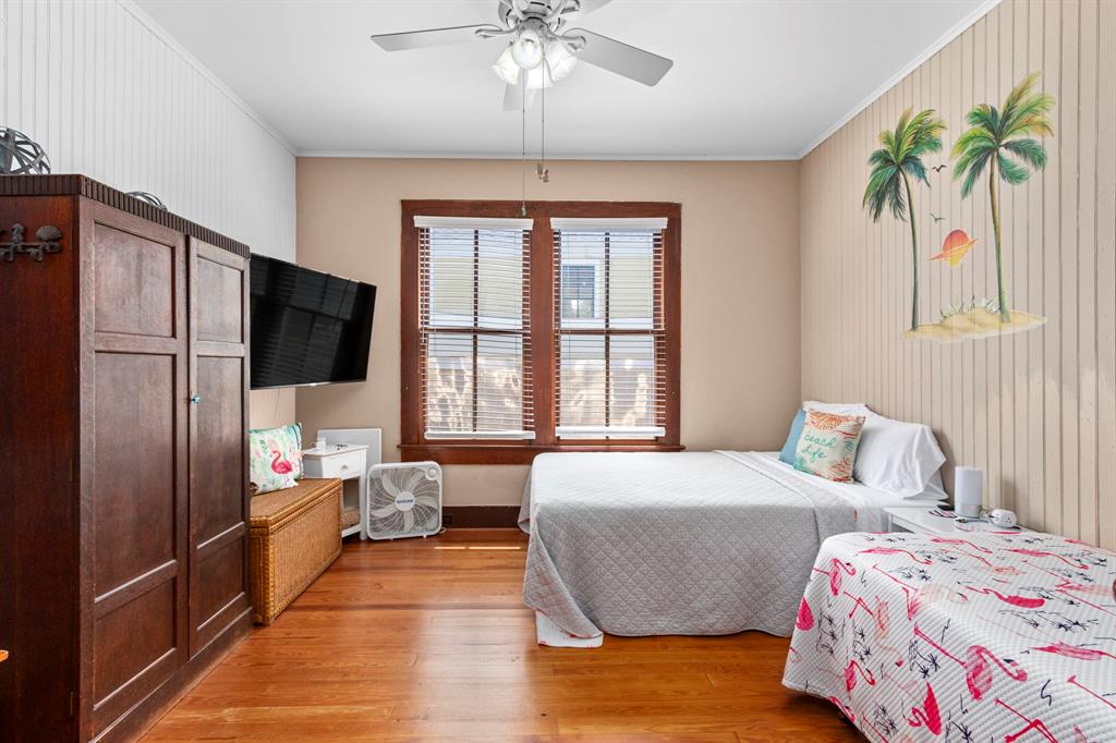 The second bedroom is large and has a Queen and twin bed for families! Notice the gleaming antique hardwoods!