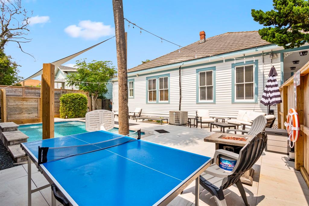 This backyard is DECKED OUT with party lights, ping pong, a fire pit for smores under the stars at night, and the pool has a poolside basketball rim!