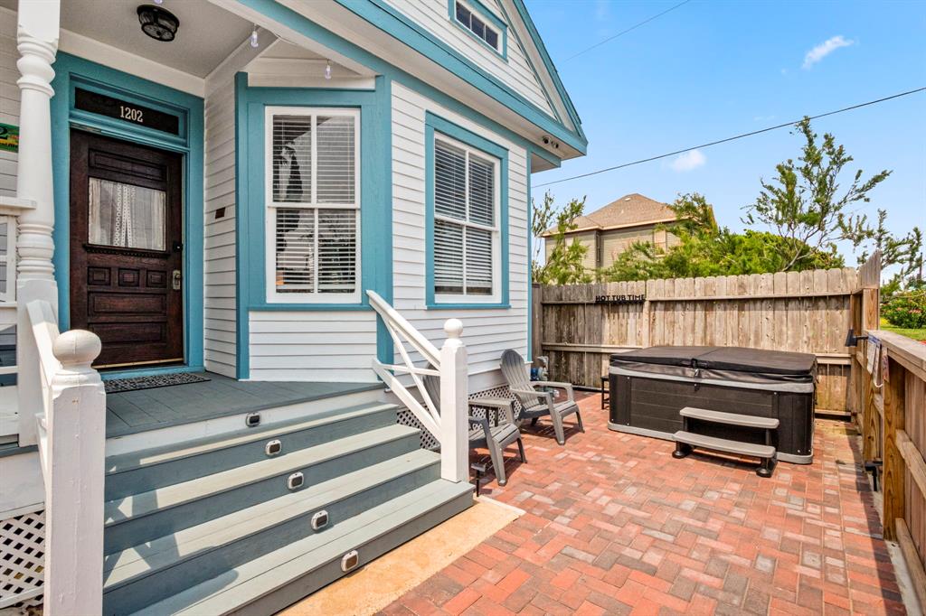 Welcome to the front fenced private patio with nice pavers and private hot tub at The Flamingo House. Notice the LED stair lights! This home has been updated nicely inside but still has the historic charm of an antique home with antique windows and front door!