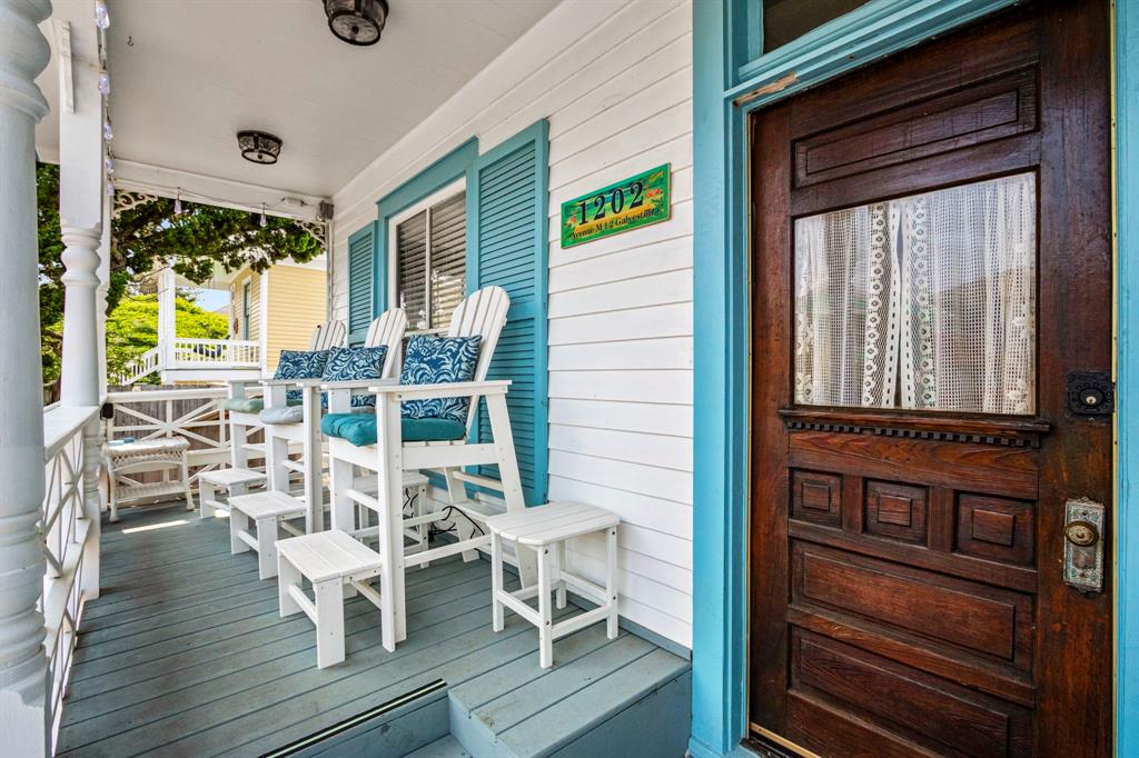 This front porch has rail height chairs for OCEAN VIEWS!!! Notice the beautiful antique front door and antique door knob. If only this front porch could talk, it would tell some tales from history!