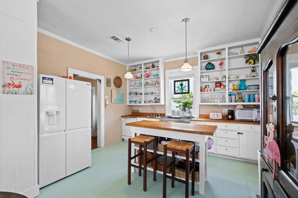 Beachy Chic kitchen with butcher block counter tops and open cabinets!