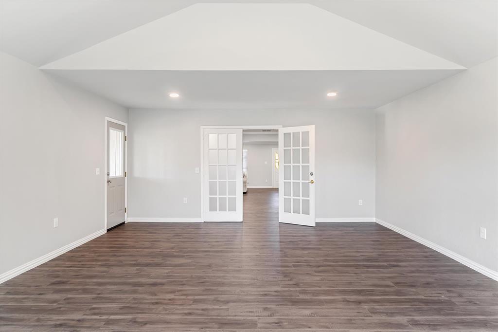 View of space showing separate entry door to back covered porch, french doors to kitchen and dining