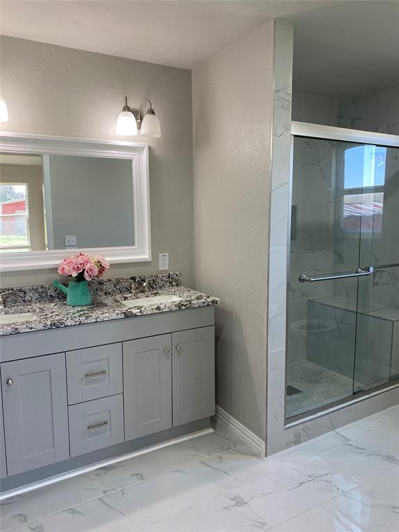 Primary En suite with gorgeous marble floor and shower.