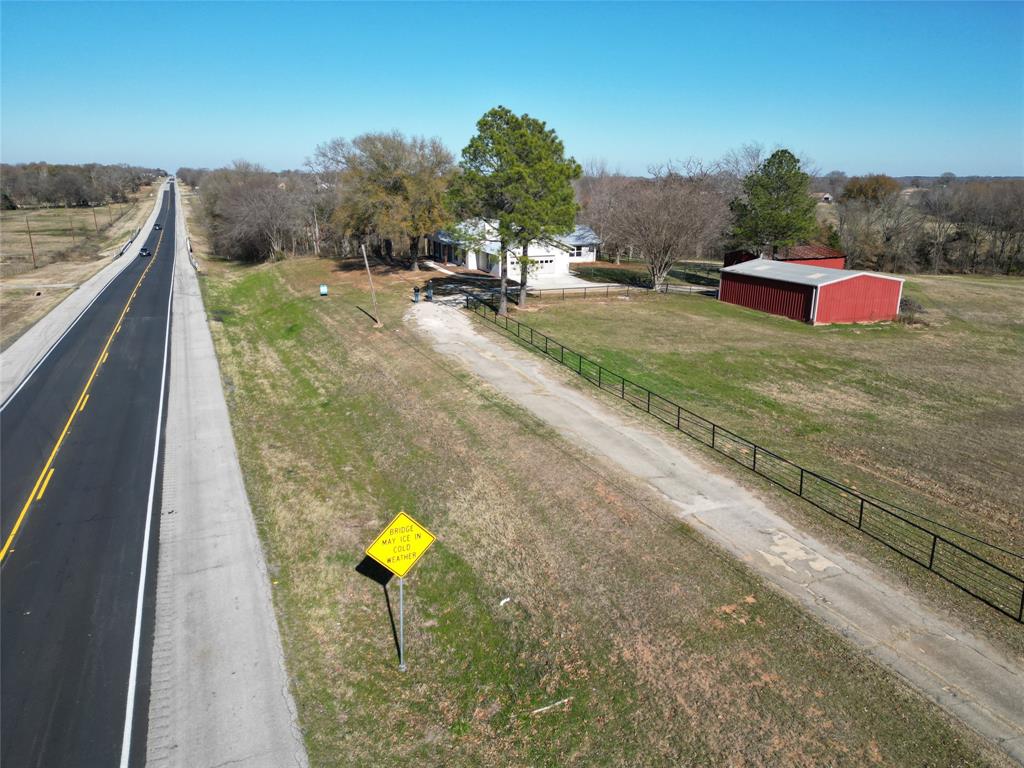 Front driveway to house.  Gate entry to acreage at Highway and between shop and barn.