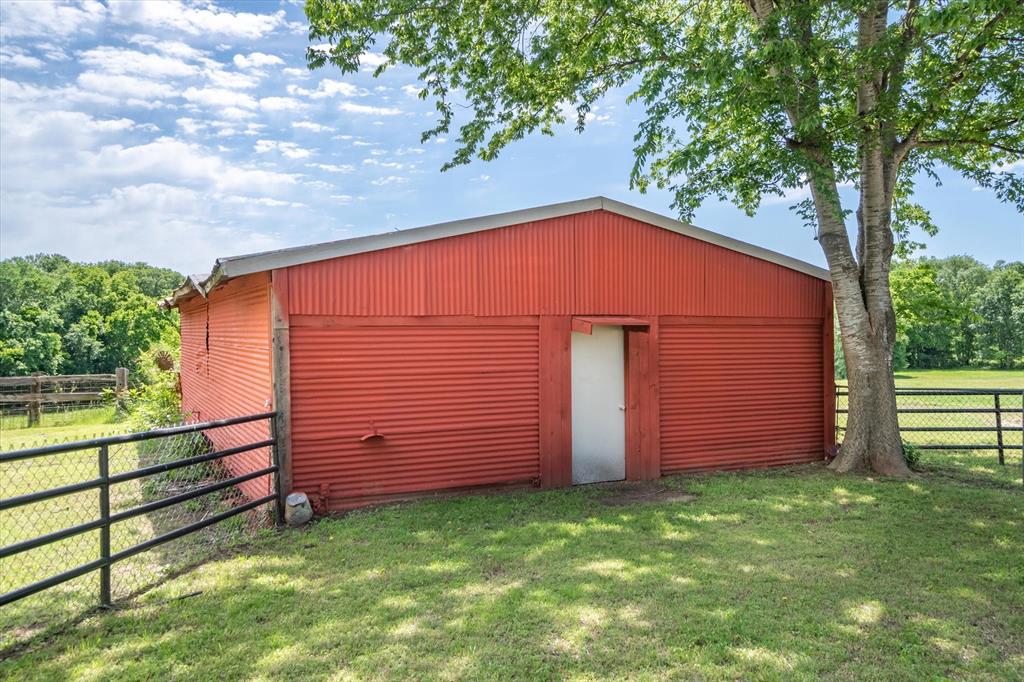 Pole Barn with electric and water, concrete slab in front with 2 stalls.