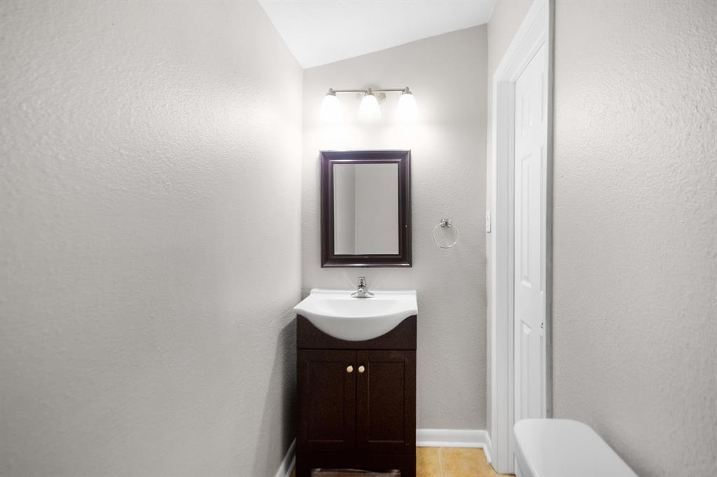 Updated half bathroom located in the hallway towards the kitchen.