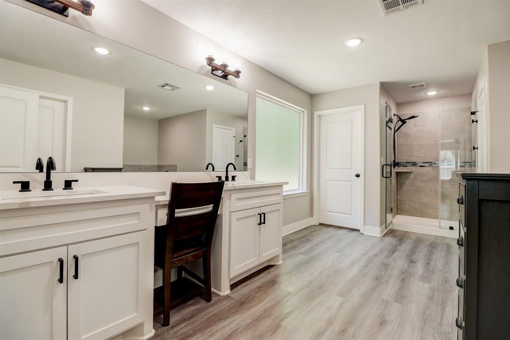 Primary bath features his and her sinks complete with vanity area