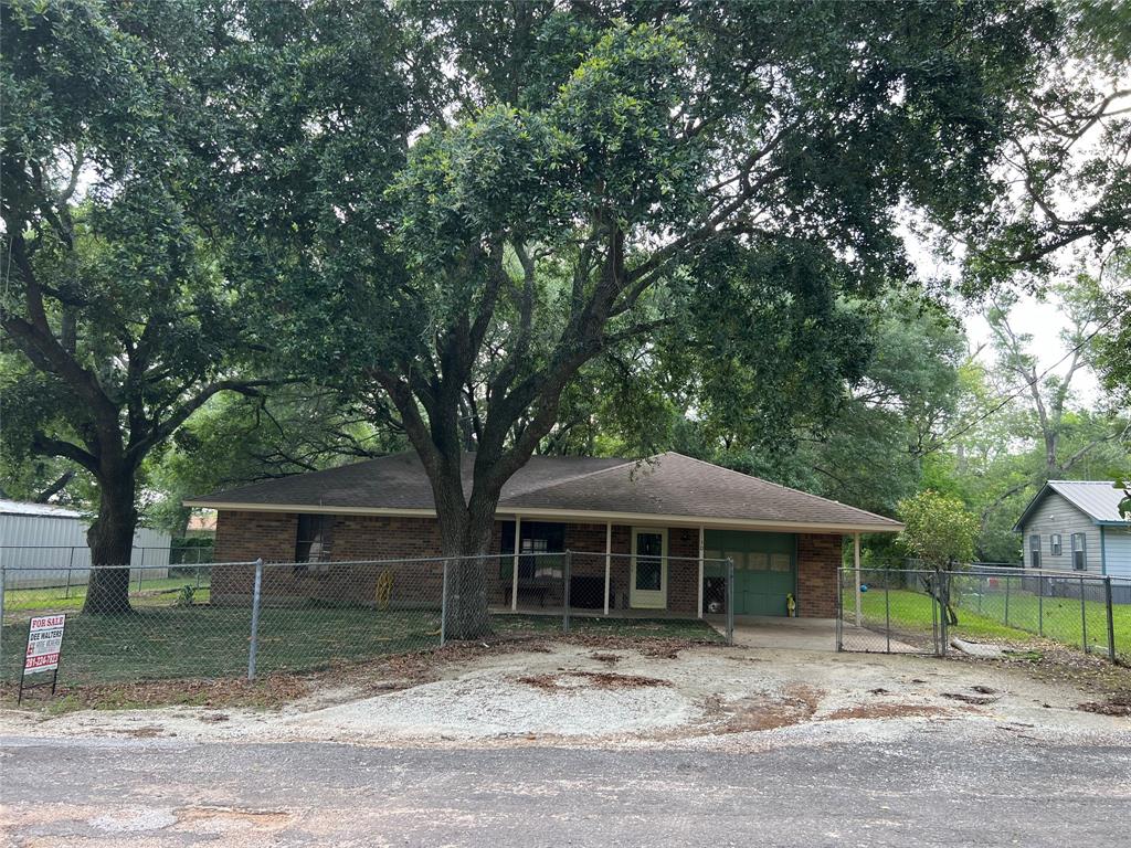 Front of the Home Looking across the street East to West. Lovely Oak Trees to enjoy the shade