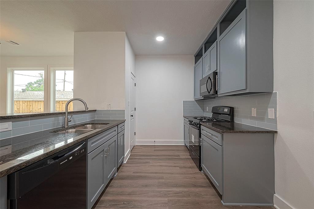 Seamlessly connected to the living room, the open floor plan kitchen is a chef\'s delight, featuring stylish grey cabinets, ample counter space, and a breakfast bar.