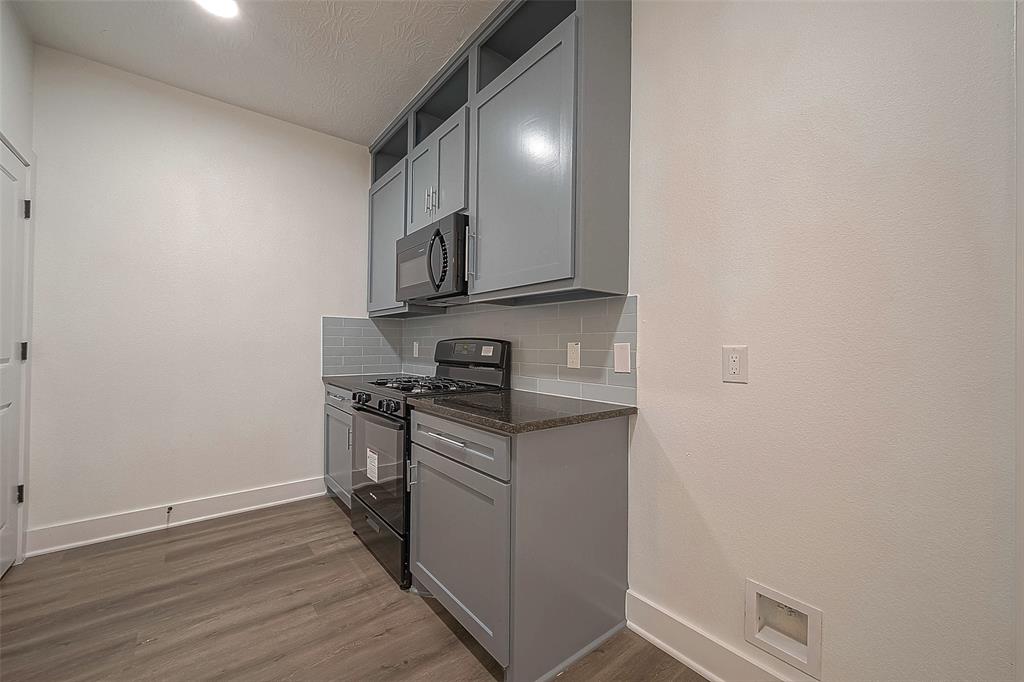 Grey cabinets provide ample storage space and create a sleek look.