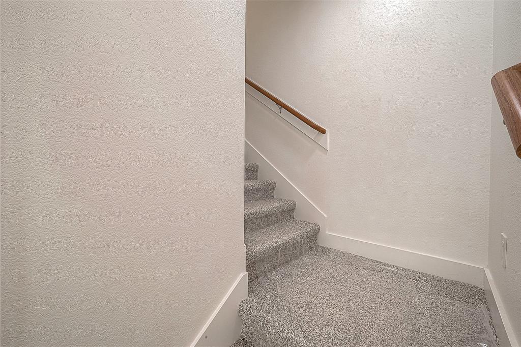 Carpeted stairs leading to the second floor.