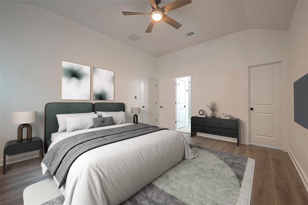 Virtually staged primary bedroom offering laminate floors, ceiling fan and an en-suit bathroom.