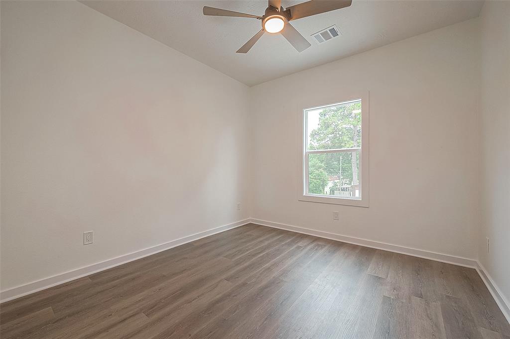 The second bedroom features laminate flooring, ceiling fan and a window, ensuring plenty of sunlight throughout the day.