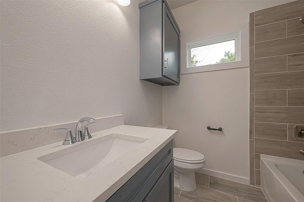 Secondary bathroom features shower/tub combo, tiled floor and sleek cabinets. Ready for your daily needs.