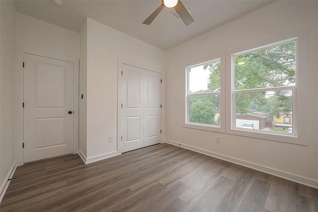 Experience the supreme comfort offered by this generously sized secondary bedroom. Abundant natural light streaming in through expansive windows creates a cozy and welcoming atmosphere throughout the room.