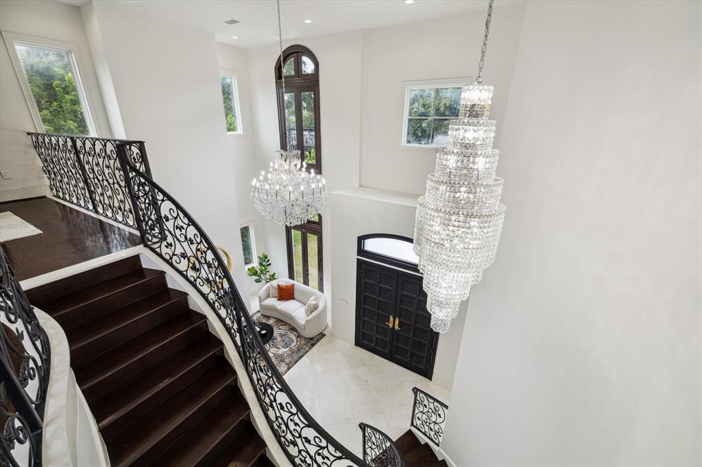 Stunning custom iron work. Other custom details include James Moder chandeliers with genuine Austrian Swarovski crystals and statement double entry solid iron front door.