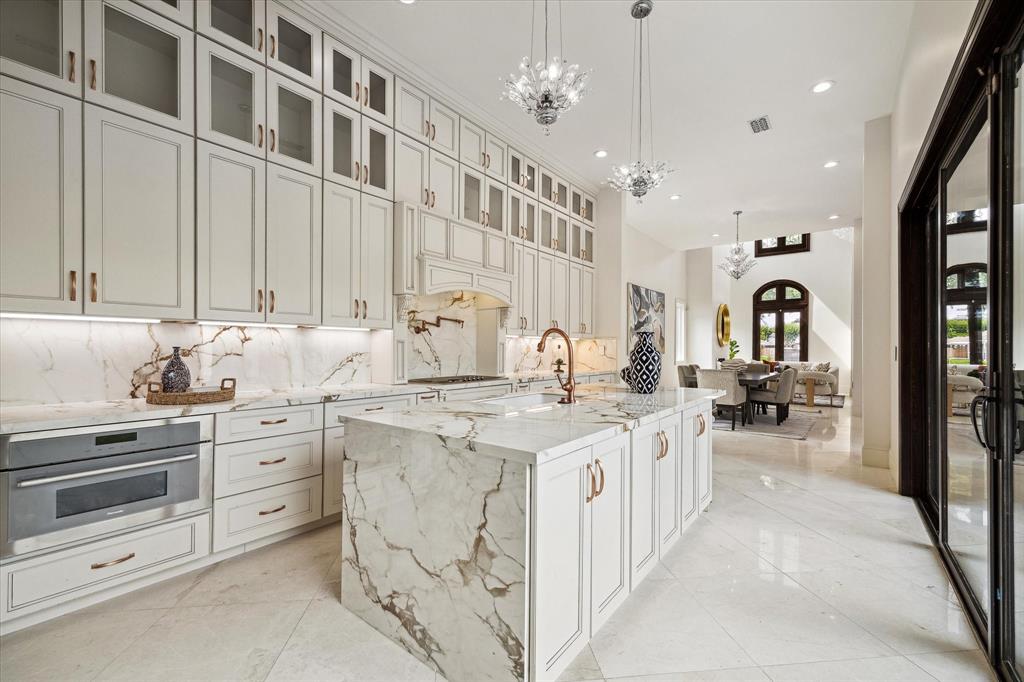 A statement chef\'s kitchen that is sure to impress with Thermador appliance package, abundance of storage, porcelain counters all overlooking backyard courtyard.