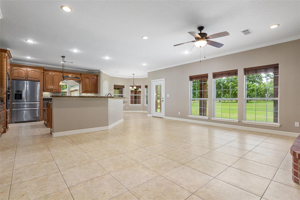 Fabulous open floor plan. French door is one of three that lead to the expansive covered patio for outdoor dining and entertaining. Large windows across the back of the home allow natural light to stream into this beautiful home.