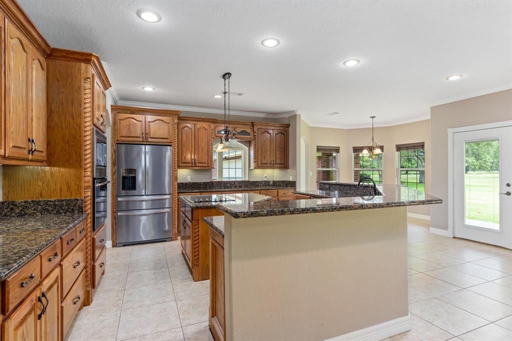 This amazing kitchen features an incredible amount of granite counter space to host and serve the largest of gatherings. Friends and family can sit and chat at the expansive 18 foot  breakfast bar that will seat 8 comfortably.