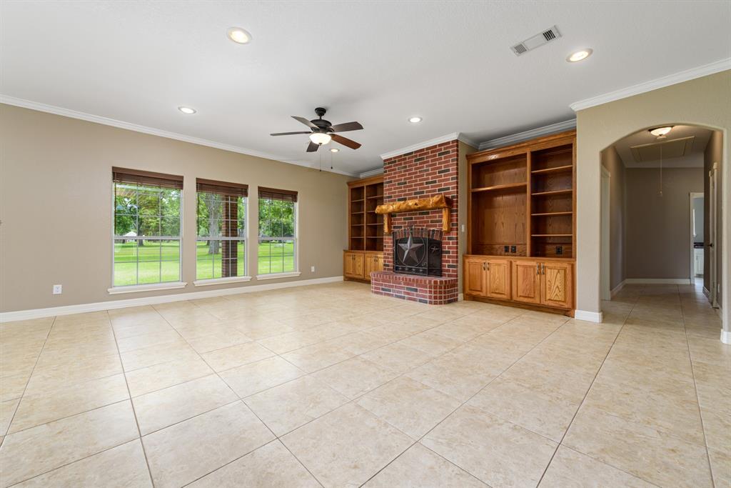 Relax and enjoy quality time in this expansive and beautiful family room. Gather around the fireplace on those chilly Texas evenings. Large windows provide spectacular views of the back acreage.