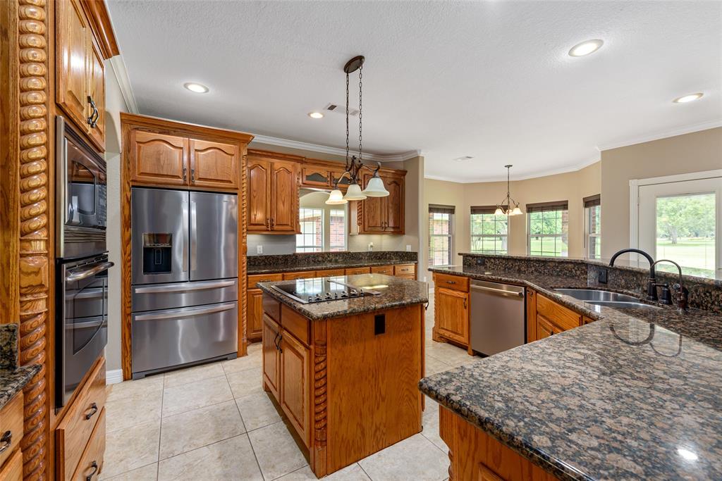 The kitchen is the heart of the home and this gorgeous one is sure to please. Beauty and function combine is this sleek island kitchen featuring an abundance of counter space,cabinets and drawers.