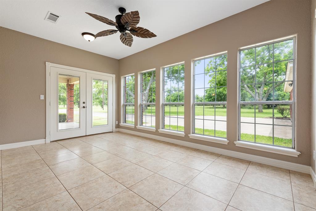 Second of two living areas. The French doors lead to one of three covered patios. Check out the incredible view. The owners have added 2 inch blinds on all windows.