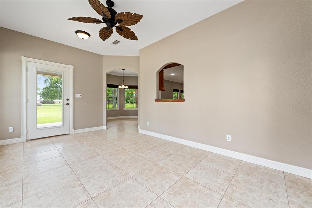 The second living area features a pass through window to the kitchen convenient for hosting large gatherings. The French door leads to the back covered patio.