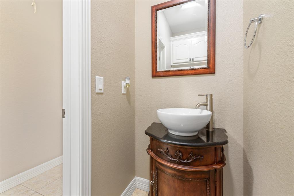 Beautifully updated half bath for guests in addition to two full baths.