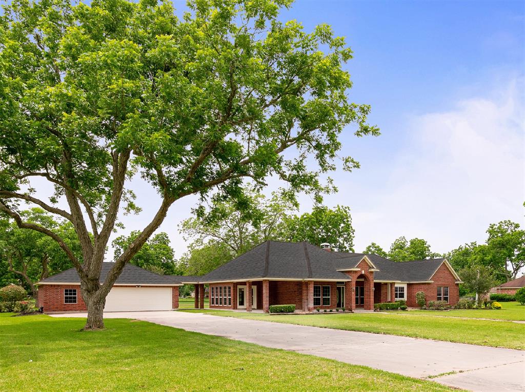 The long concrete driveway leads to a widened pad in front of the oversized detached garage allowing ample room for guest parking.