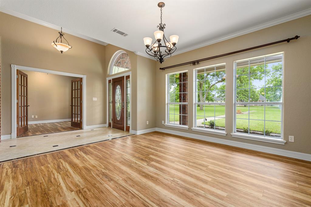 Spacious formal dining room with high ceiling, crown molding and a beautiful chandelier. Dining room is open to the foyer and kitchen,perfect for entertaining or hosting the largest of family gatherings.