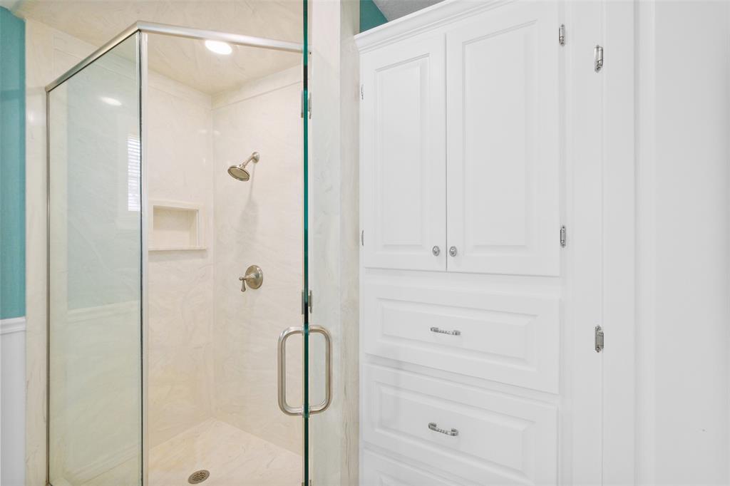 Secondary bath features attractive built ins for all of your storage needs!