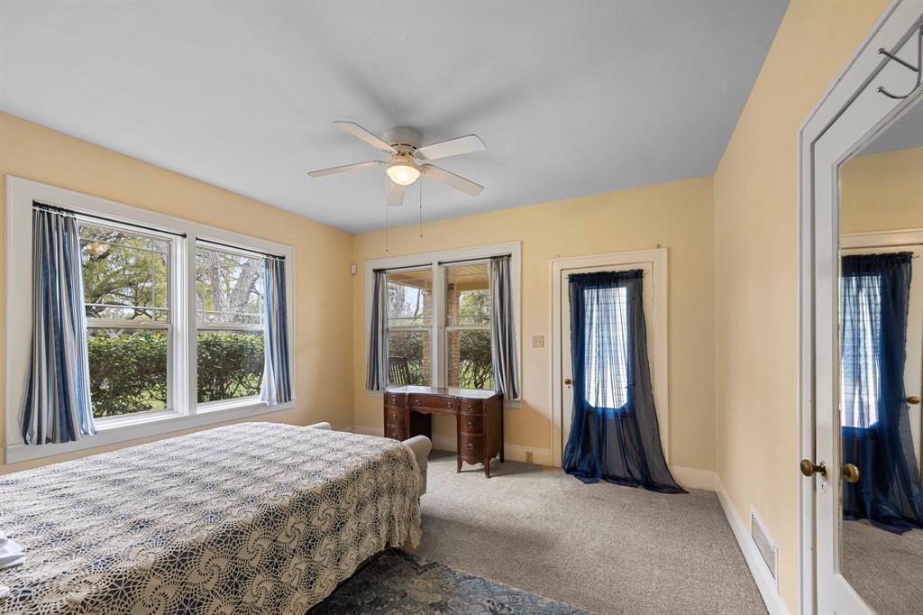 The second bedroom with door to the covered front porch. All bedrooms are generously sized with ample closet space.