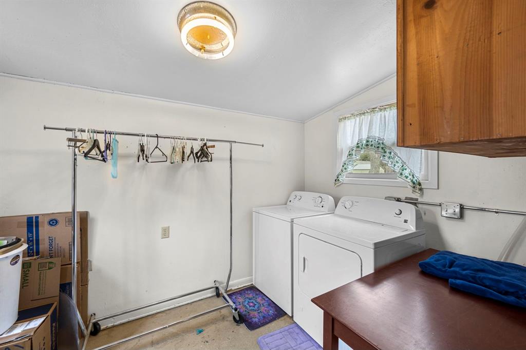 Large laundry/mud room with built in shelving.