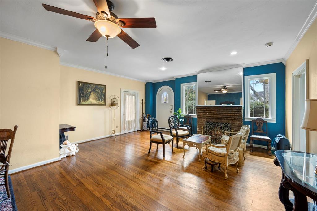 Welcome home! Entertaining guests will be a breeze in this amazing home. This living area is one of two large  living rooms. Note the high ceilings and gorgeous wood floors.