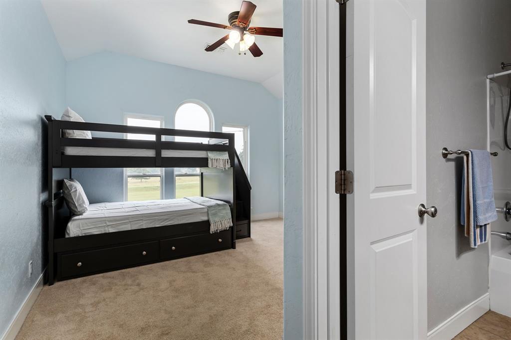 Spare bedroom 1 with carpet and ceiling fan and oversize closet.  Spare bathroom 1 is located inside this bedroom.