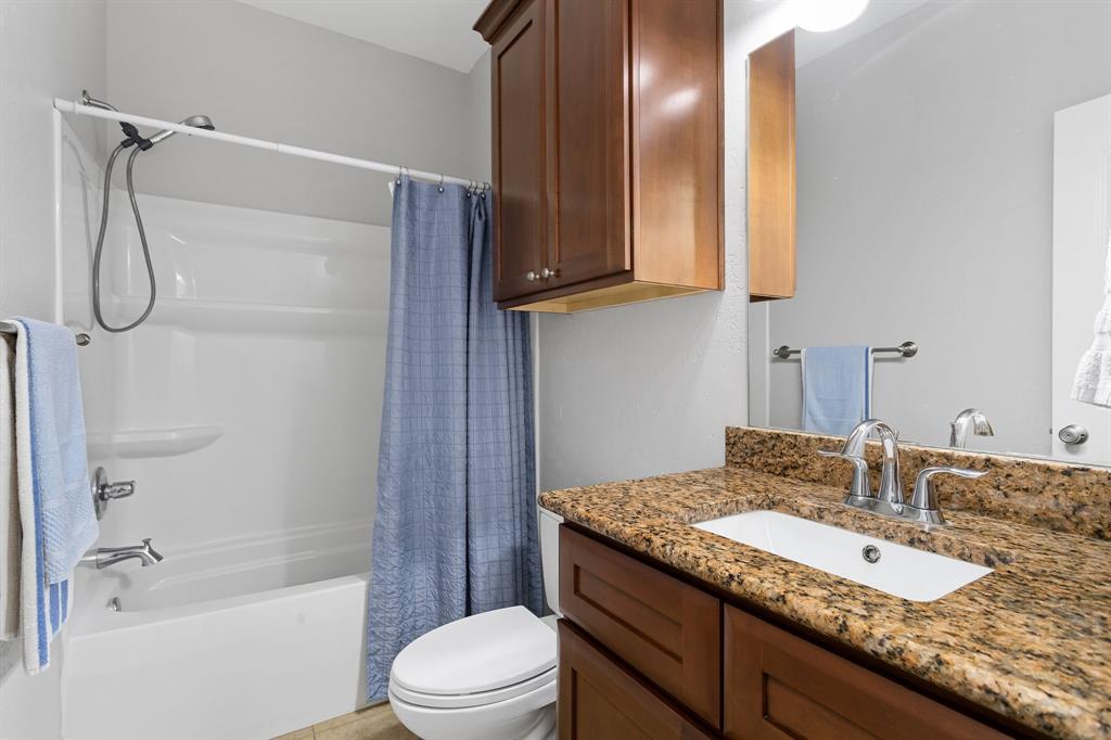 Spare bathroom 1 located inside spare bedroom 1. Granite countertops & tile flooring.