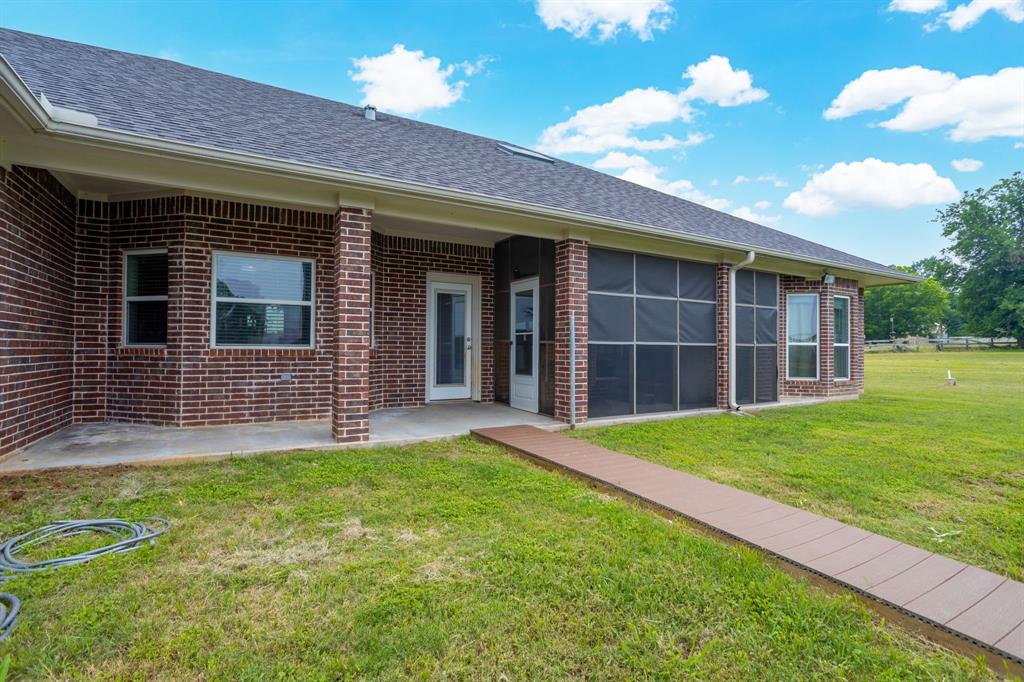 Covered back porch, screened in porch and walkway to above ground pool and wood deck.